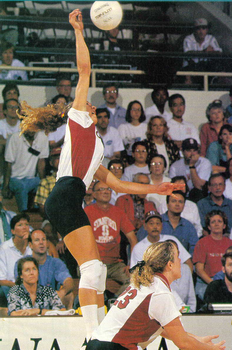 Womens Volleyball player reaching high to kill the ball